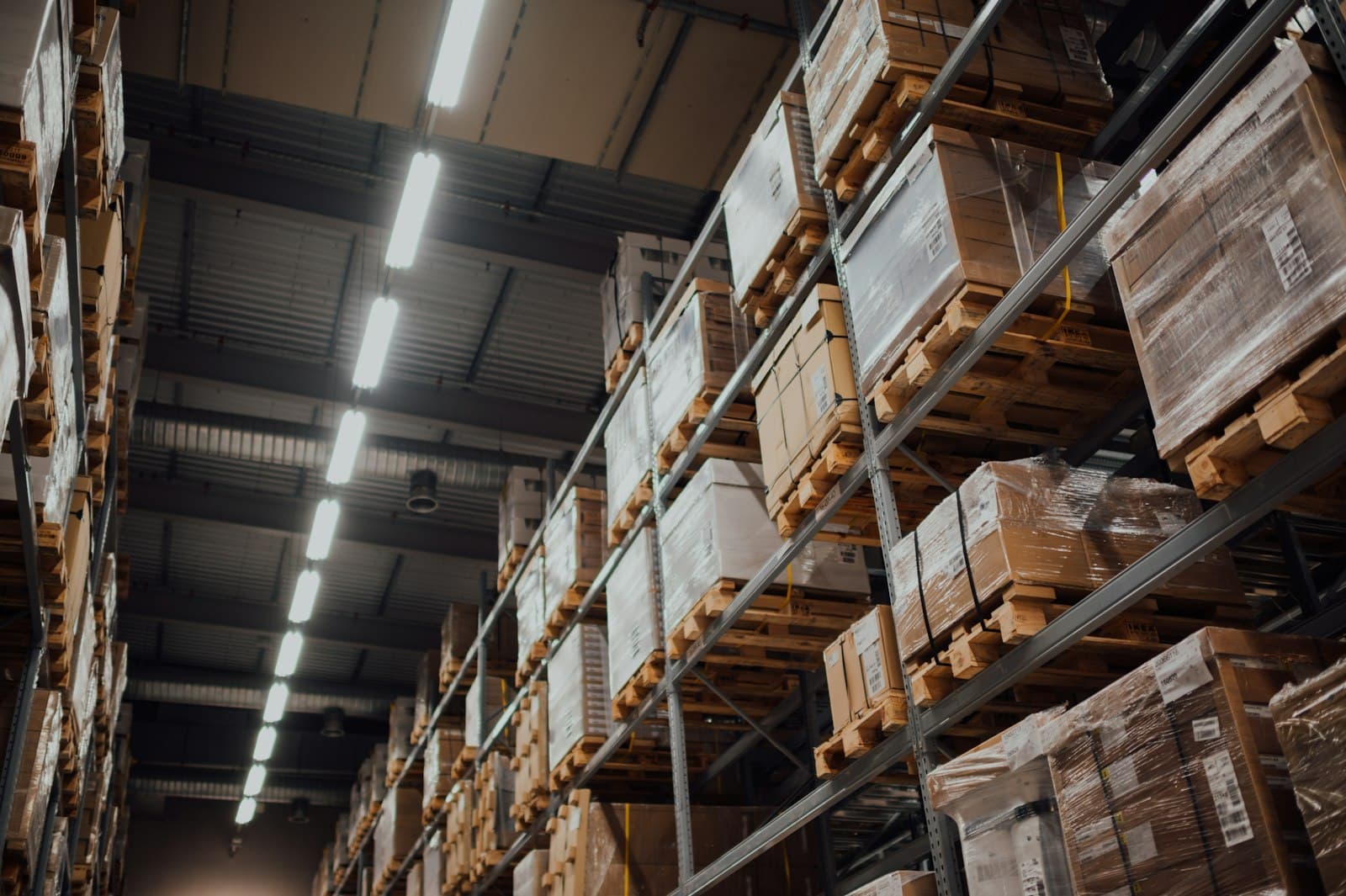Pallets and cartons on racking in a distribution warehouse.
